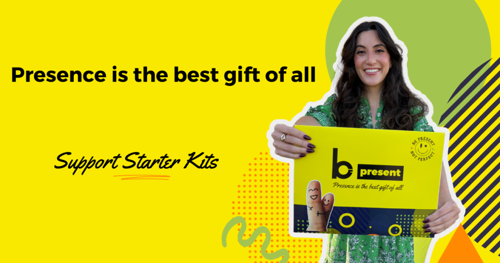 A smiling woman holding a yellow and black b present box stands on a bright yellow background with text reading “Presence is the best gift of all” and “Support Starter Kits.” Decorative shapes and patterns surround her.